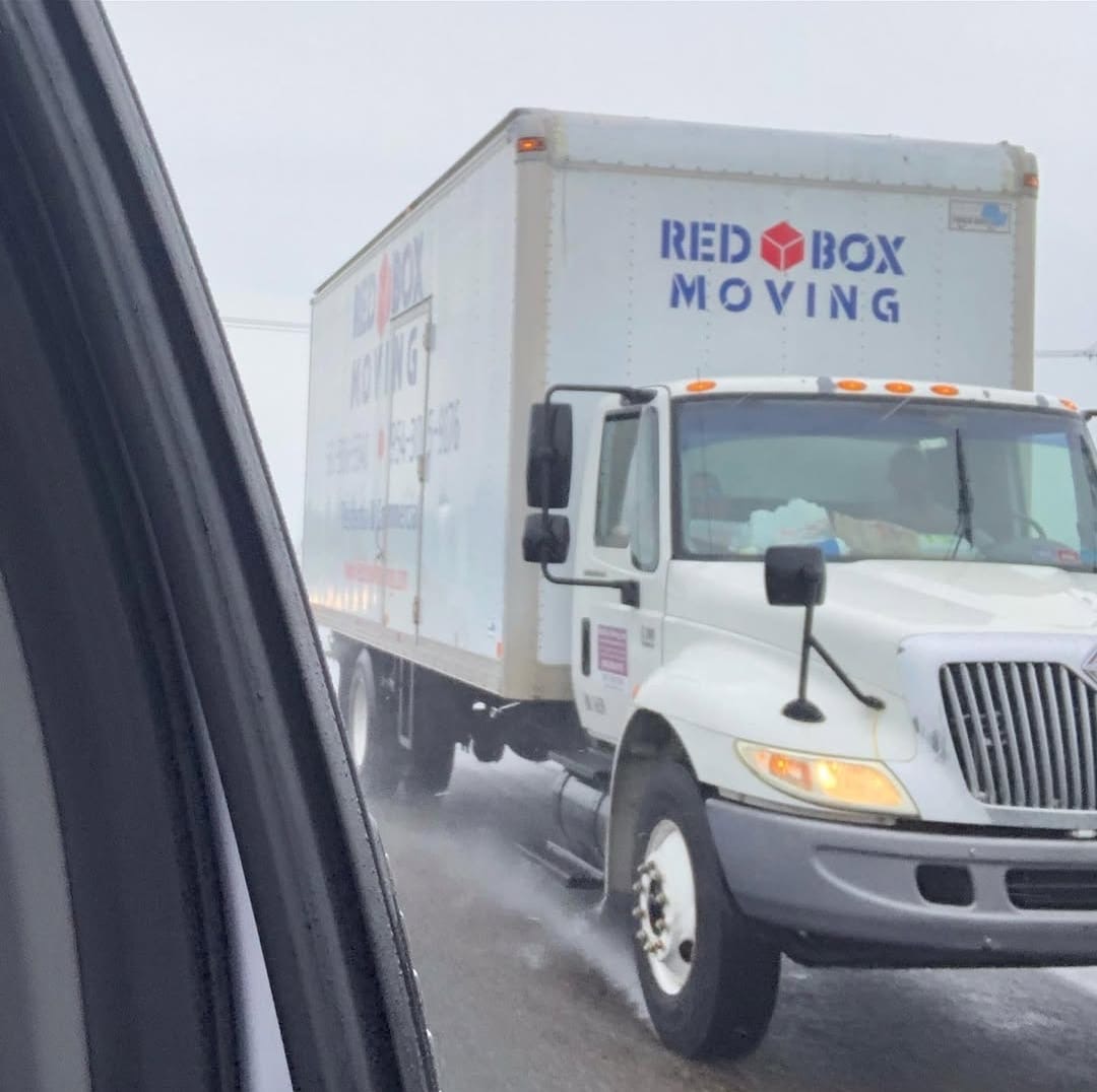 Red Box Moving branded truck on the highway for a long distance move
