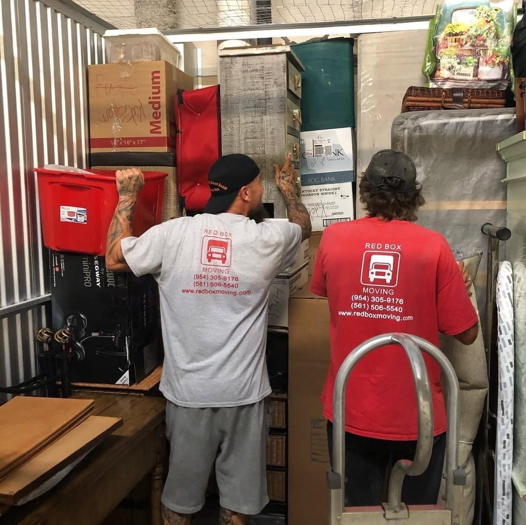 Red Box Moving crew moving furniture in a commercial space